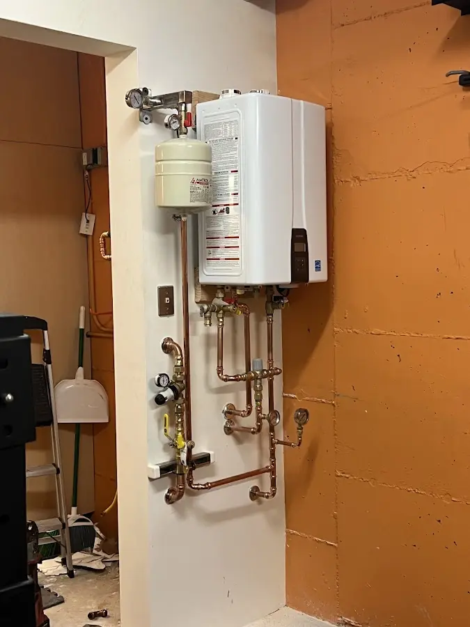 Plumbing technician inspecting water heater connections in Myerstown